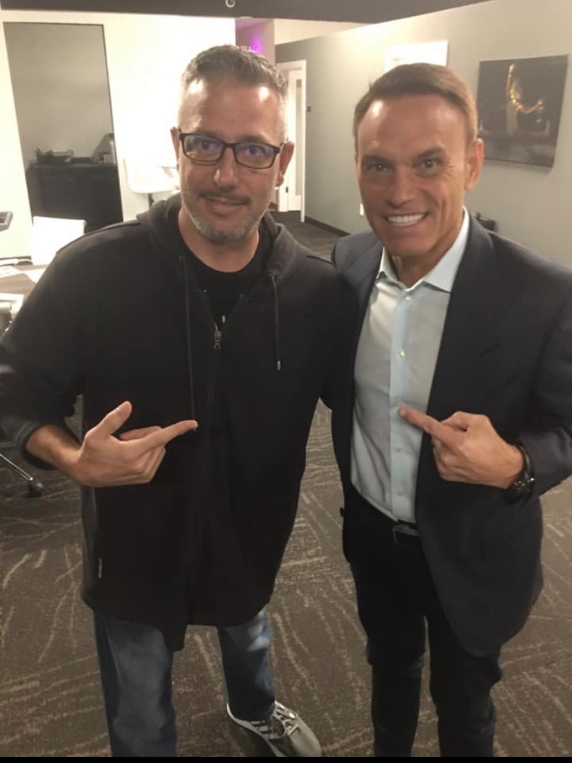 Spotlight Media founder and Kevin Harrington pointing at each other