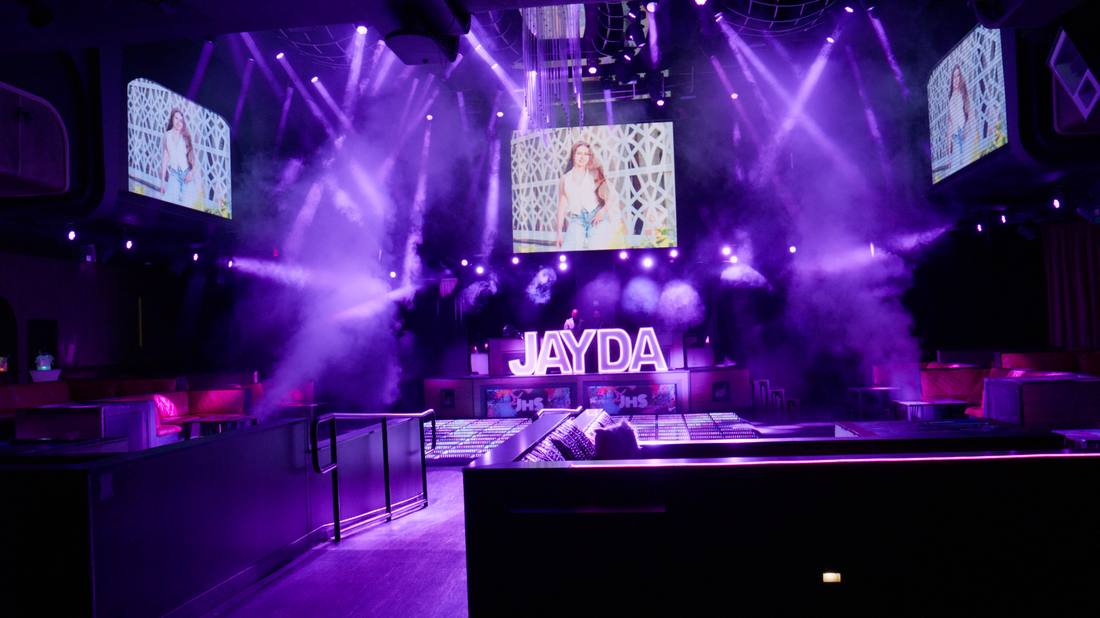 JAYDA nightclub venue lit with purple stage lighting and video screens