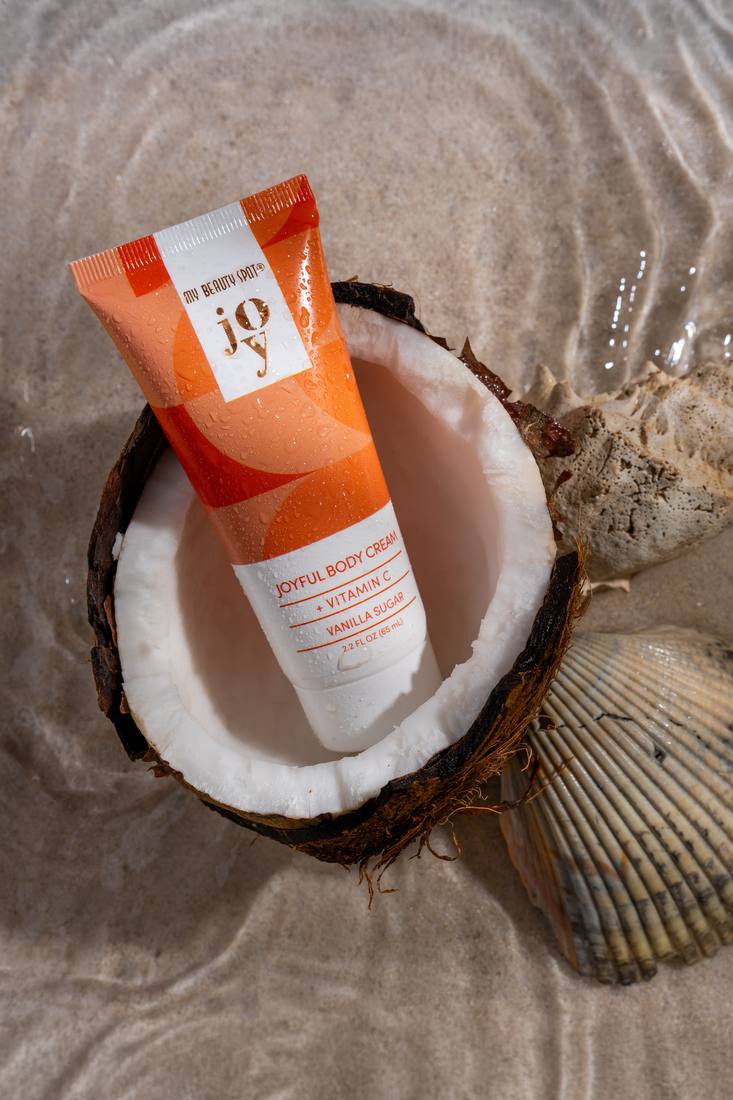 Body-cream product styled with a fresh coconut